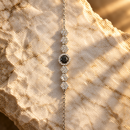 Black gemstone bracelet on marble, golden-hour