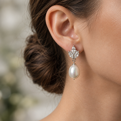 Close-up on-model shot of crystal leaf pearl drop earrings, face not shown