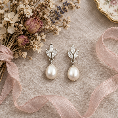 Crystal leaf pearl drop earrings flat-lay with dried flowers